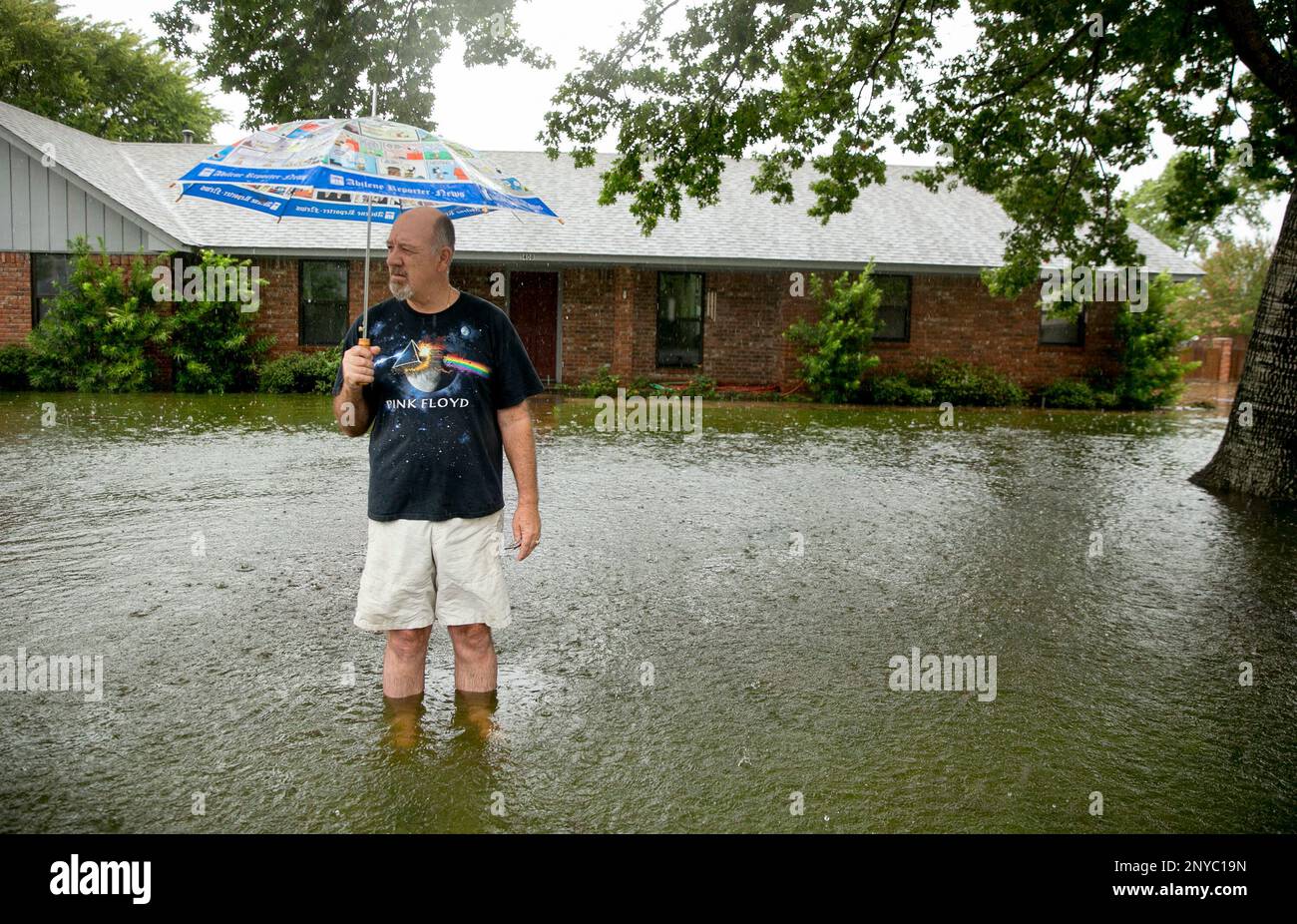 David Spencer looks at the flooding in his front yard on NE 7th Street