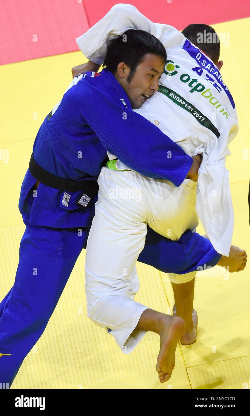 Naohisa Takato of Japan, in blue, and Orkhan Safarov of Azerbaijan fight in the final of the mens 60kg category during the Judo World Championships in Budapest Papp Laszlo Sports Arena in