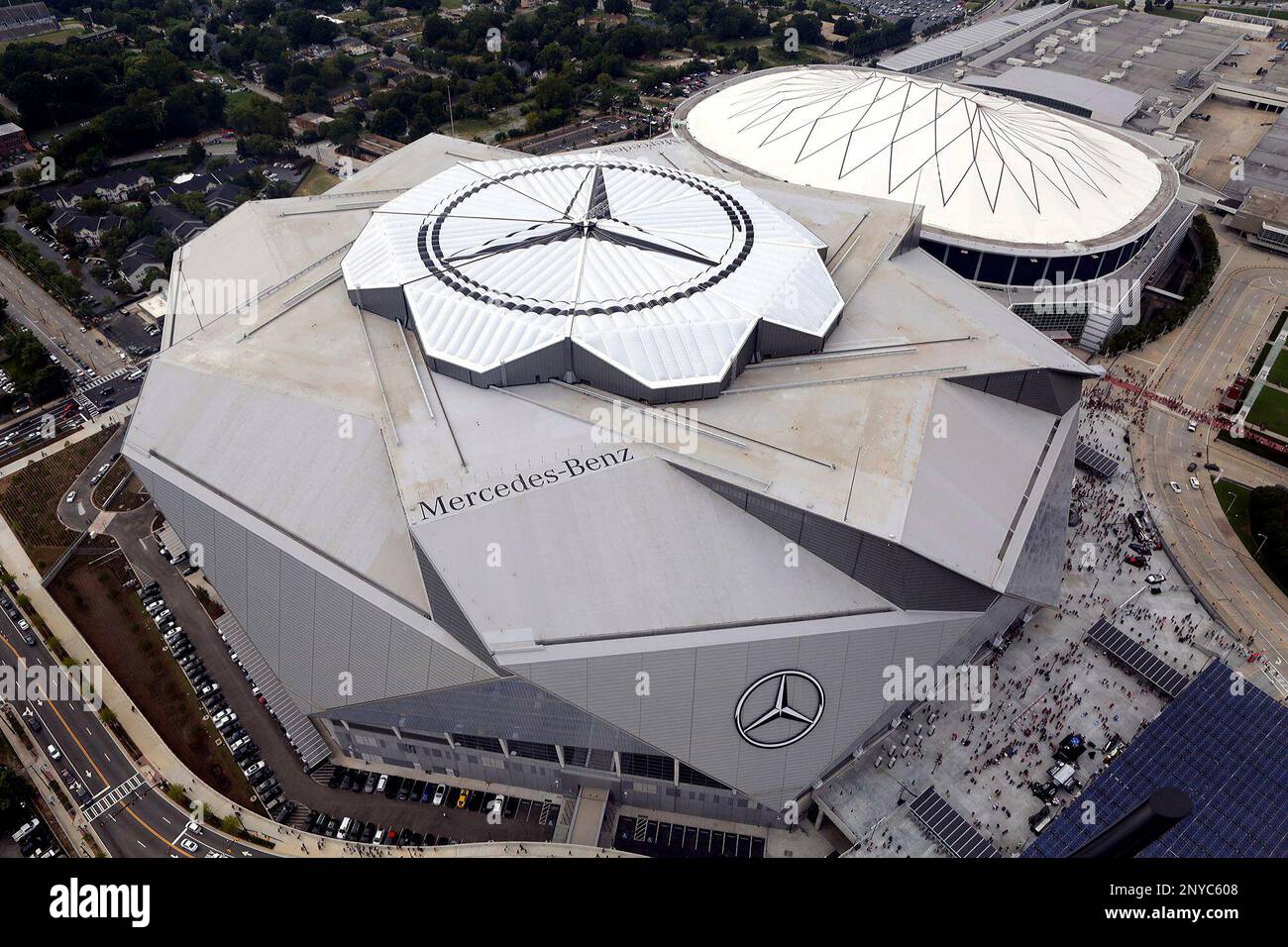 The new Mercedes-Benz Stadium, foreground, stands next to the Georgia Dome  in aerial photo before an NFL preseason football game between the Atlanta  Falcons and the Arizona Cardinals, Saturday, Aug. 26, 2017,