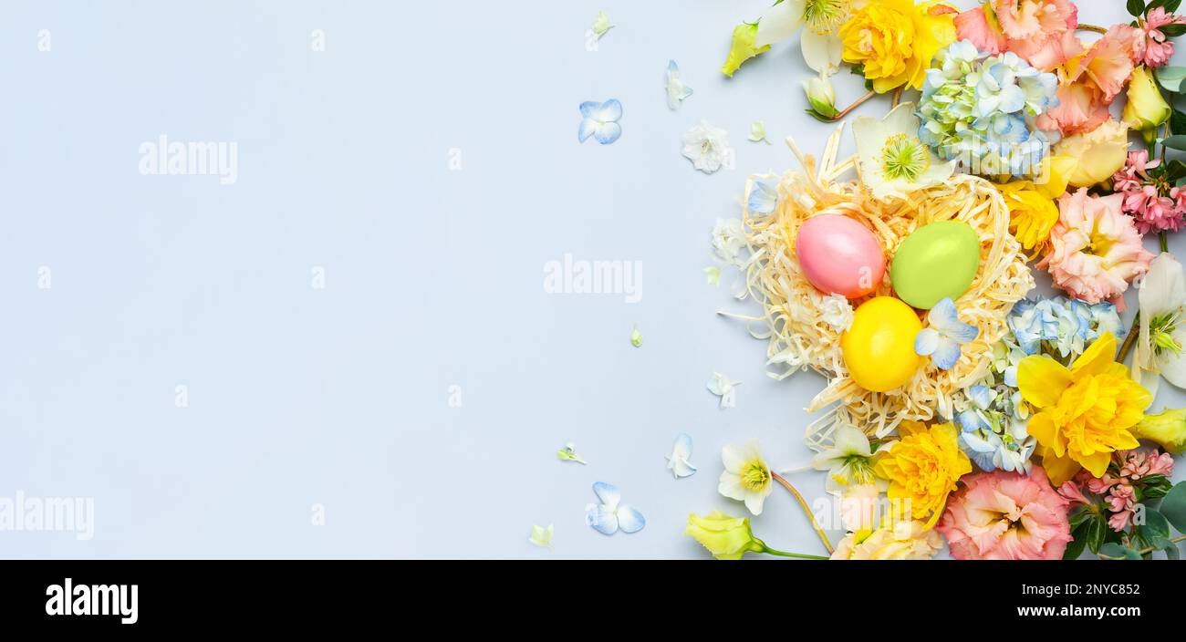 Easter composition with Spring Flowers and Easter eggs in nest on ...