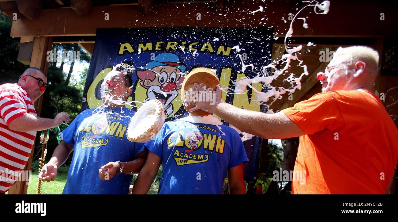 Lee Andrews, of Forsyth, Ga., left, tosses a pie into the face of Andy  Espinosa of Arlington, Texas, as his father Toty Espinosa, also from  Arlington, Texas, gets a pie from Jeffrey