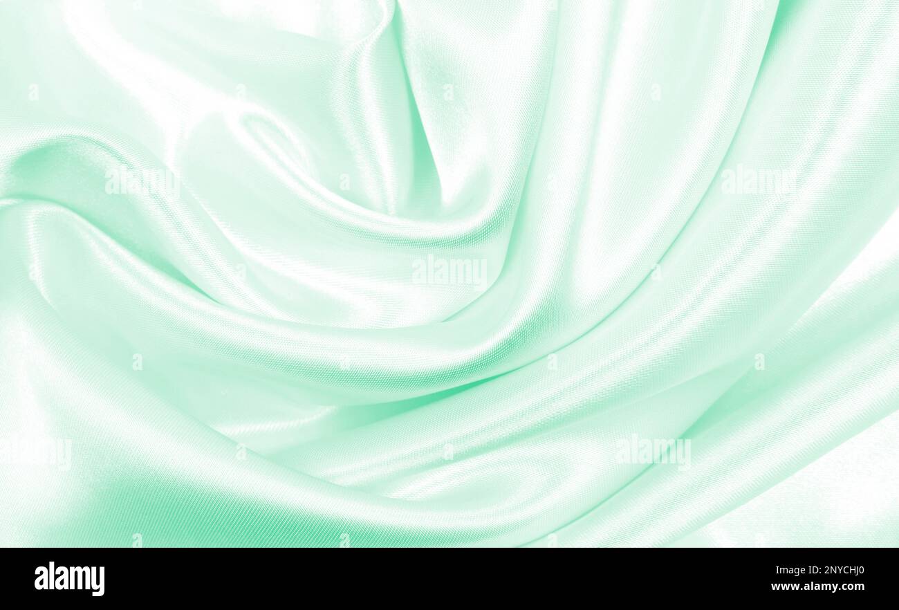 Smooth elegant green silk or satin luxury cloth texture can use as ...