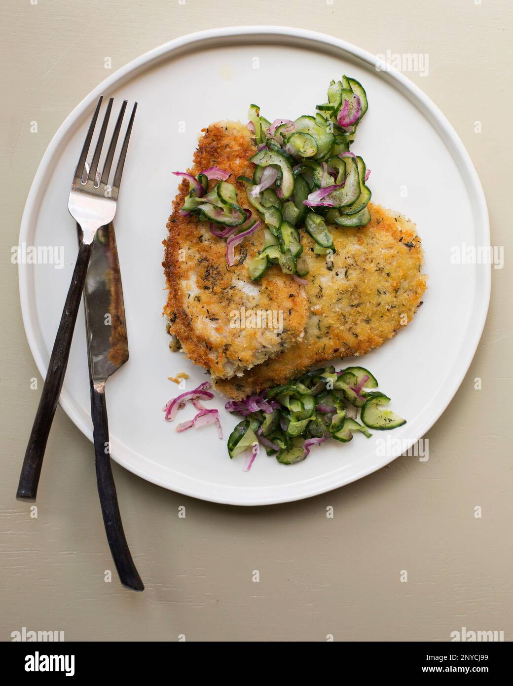 This June 2017 photo shows pork schnitzel with cucumber salad in New