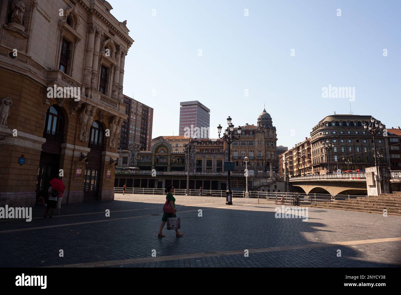 Bilbao, Spain - August 02, 2022: View of the Arriaga theater, Arenal Bridge on the Nervion river and La Concordia Railway Station Stock Photo