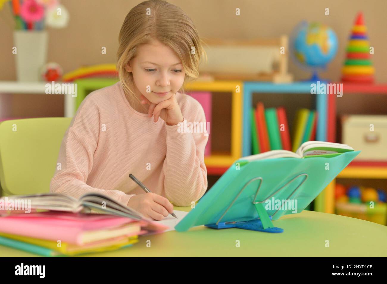 little girl doing homework at the table at home Stock Photo - Alamy