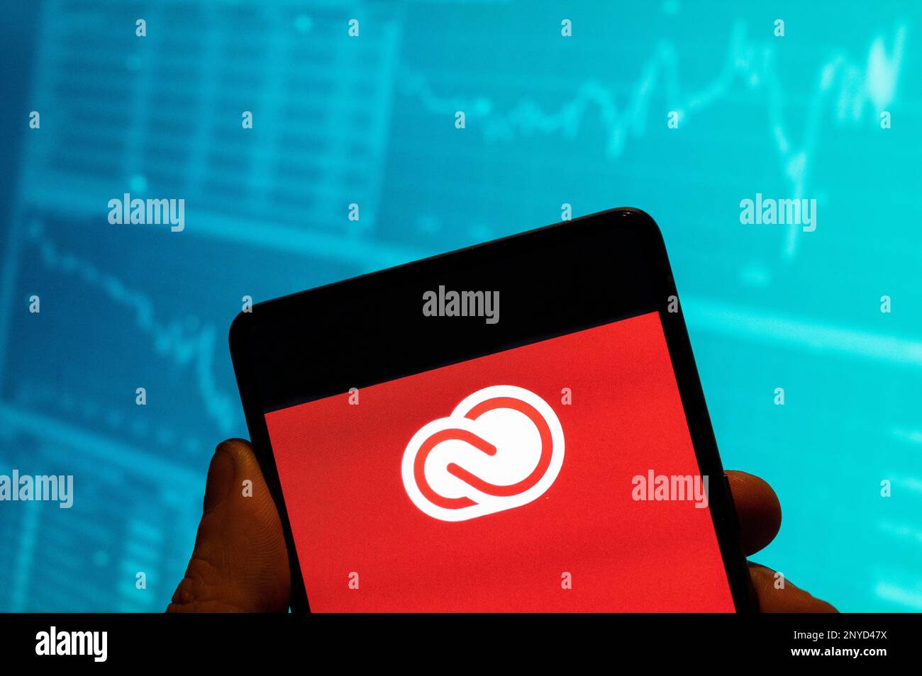 China. 19th Feb, 2023. In this photo illustration, the file hosting service and computer software access owned by Adobe Systems, Adobe Creative Cloud, logo is seen displayed on a smartphone with an economic stock exchange index graph in the background. Credit: SOPA Images Limited/Alamy Live News Stock Photo