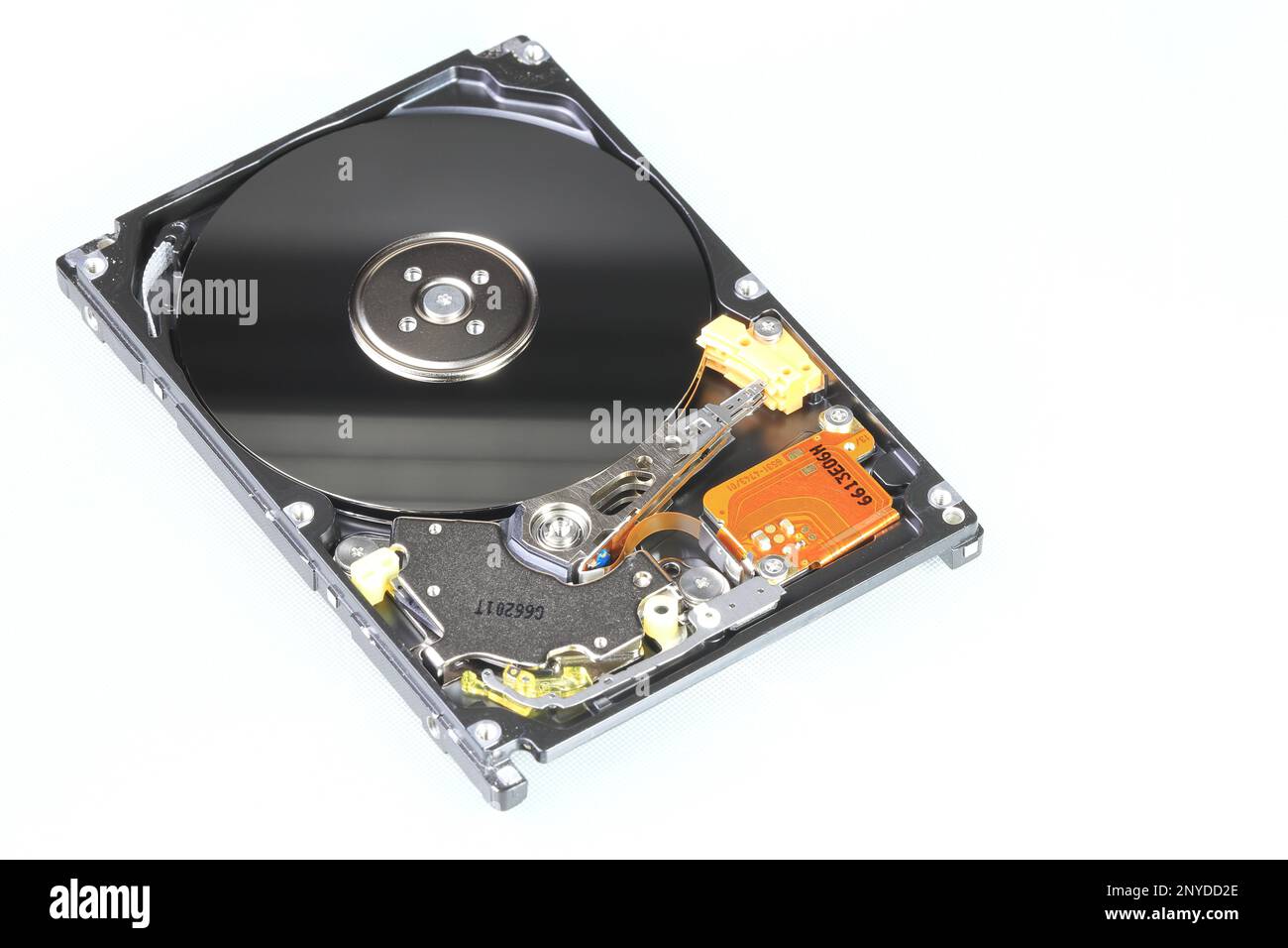 view of internal computer hard drive 2.5' SAS, can see disk surface and head with shallow focus isolated on white background. Stock Photo
