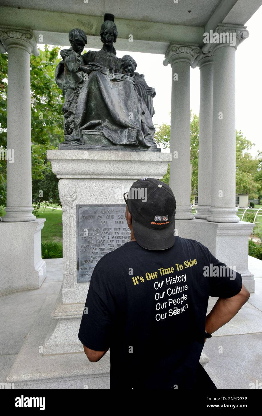 Joe Ross, with the Northside Coalition, looks at the statue in the