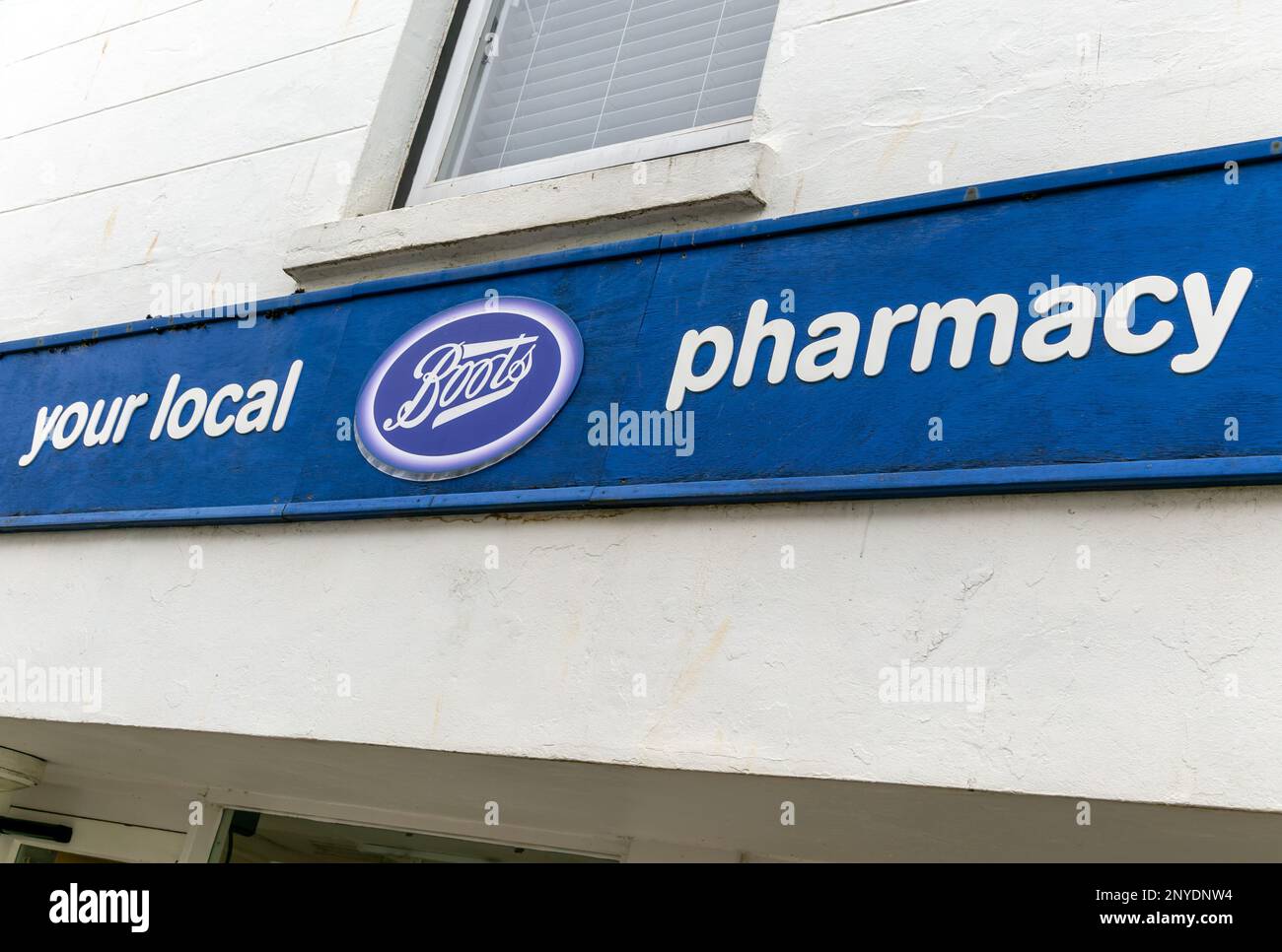 Boots Your Local Pharmacy sign outside chemist shop, Salcombe, Devon, England, UK Stock Photo