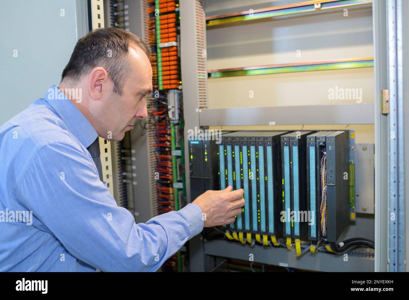 technician in server room at the data centre Stock Photo