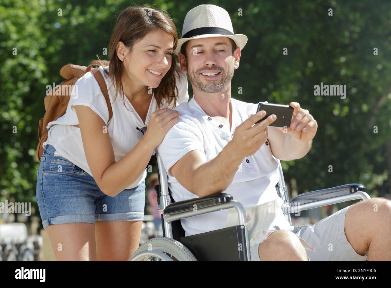 girlfriend and man in a wheelchair making a selfie Stock Photo - Alamy