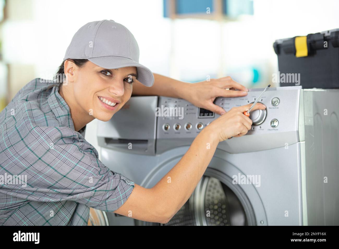 laundry worker taking notes about broken machine Stock Photo Alamy