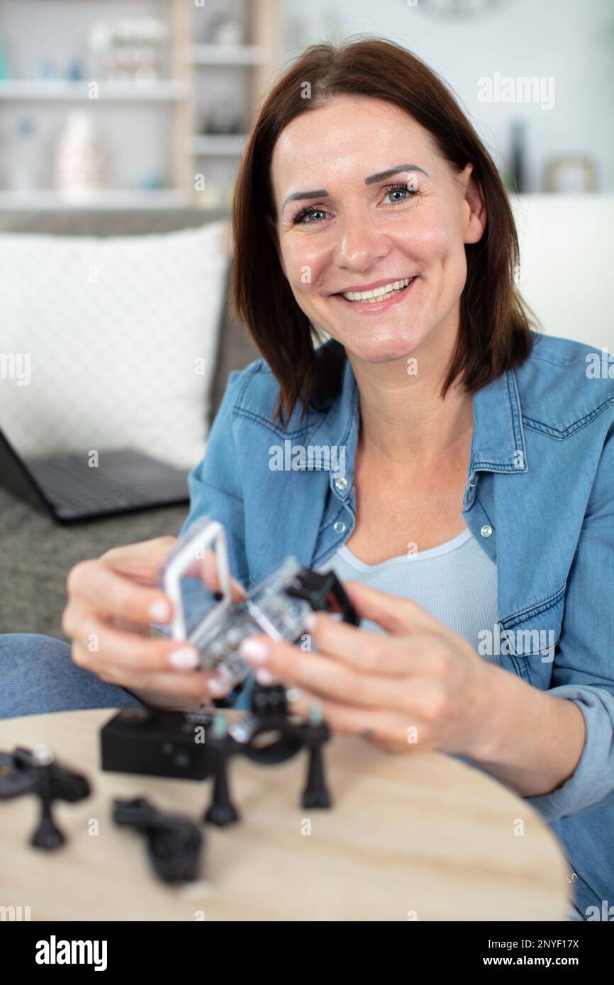 female engineer or tech repairs electronic device Stock Photo