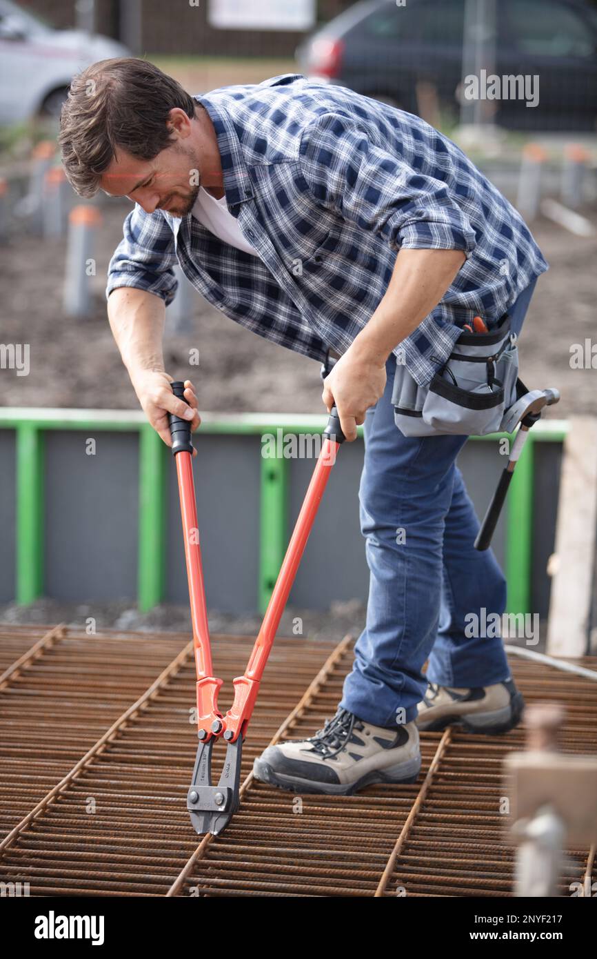 plumber cutting a pipes with a pipe cutter Stock Photo Alamy