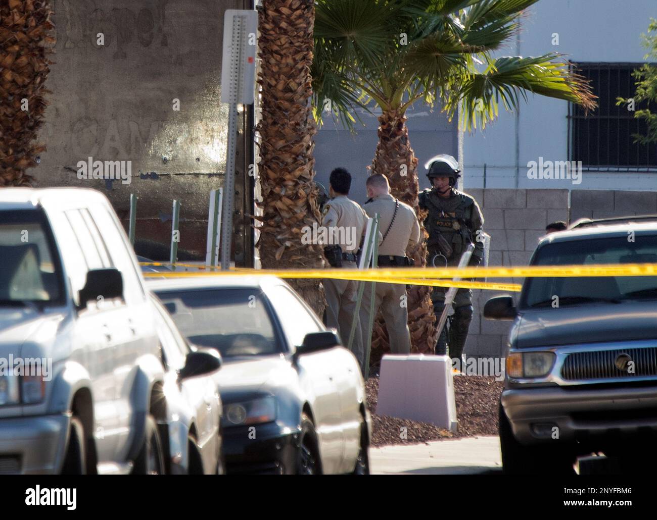 Metro Police officers confer near a shooting scene in Las Vegas ...
