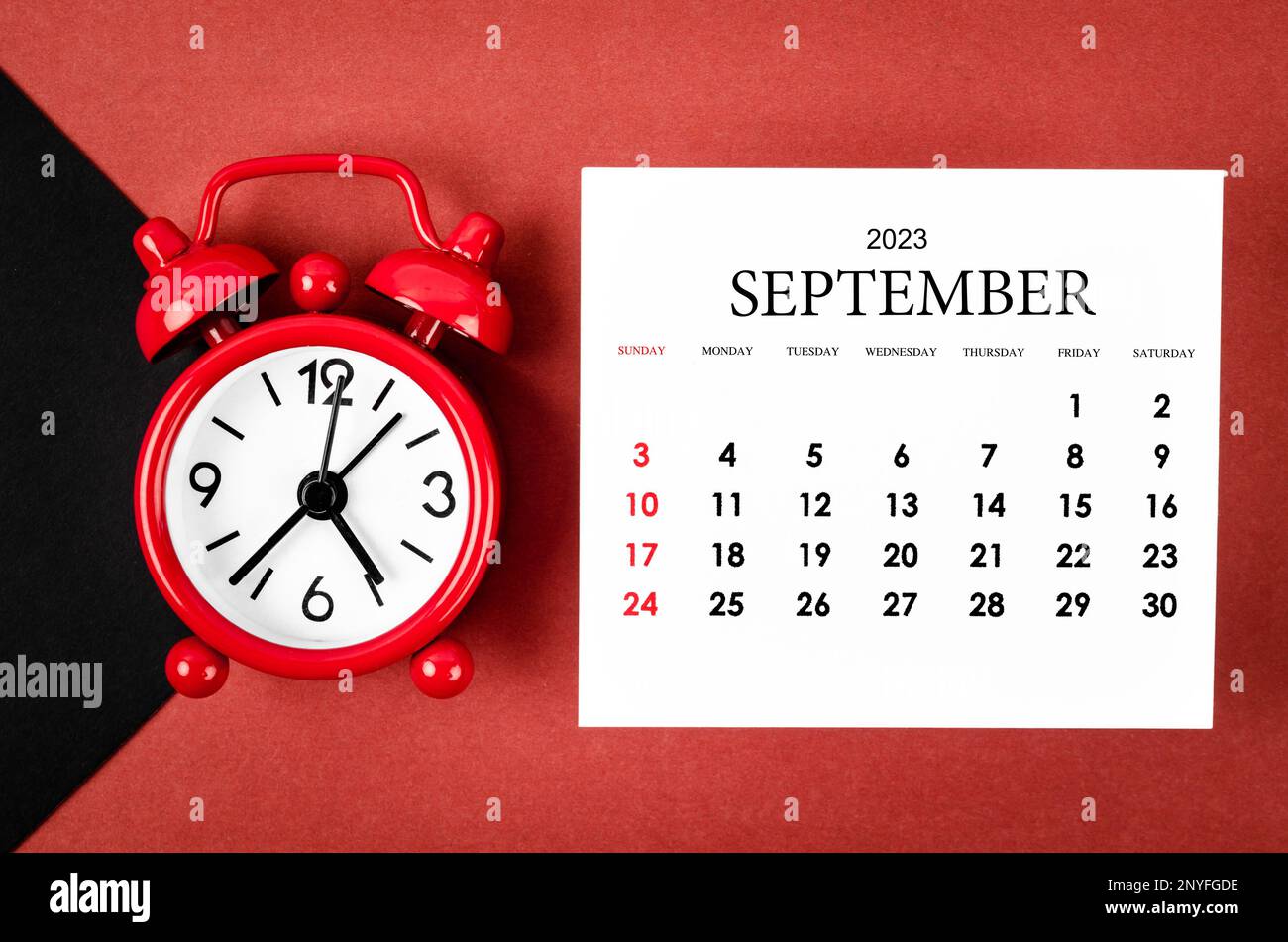 September 2023 Monthly calendar year with alarm clock on red and black ...