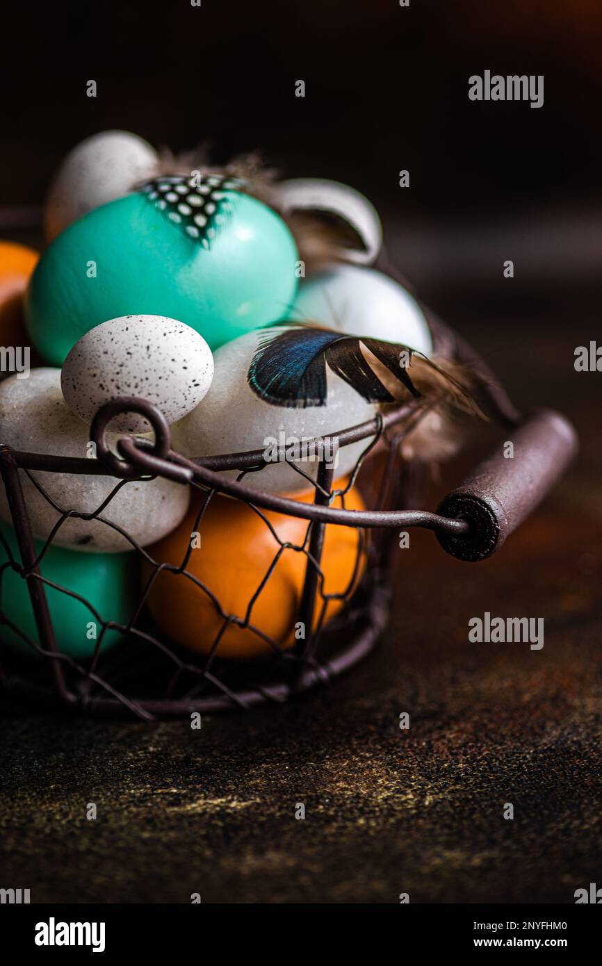 Basket with easter card concept with eggs on rustic brown background Stock Photo