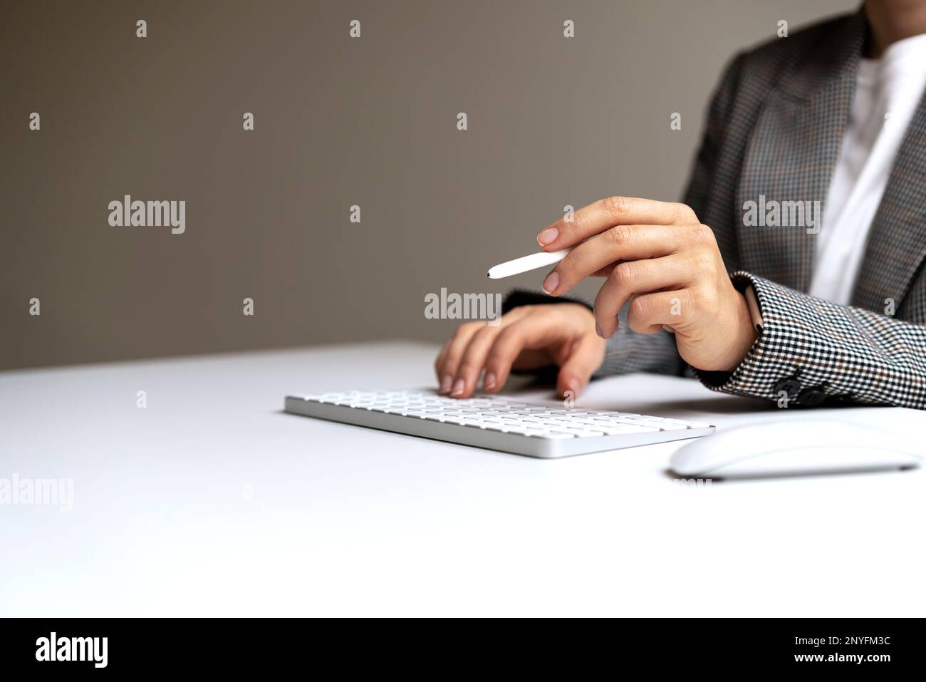 Female business person holding digital pen in hand signing virtual contract. Stock Photo
