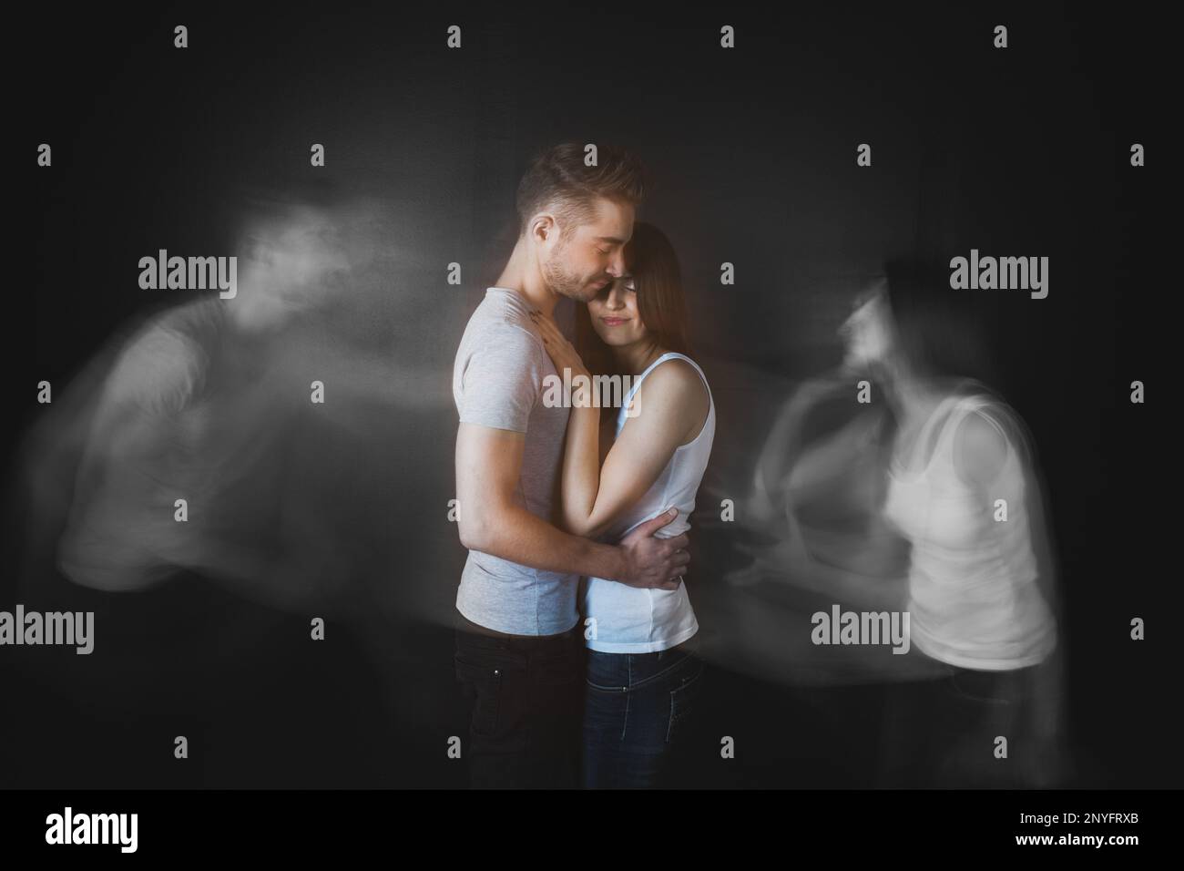 Couple embracing posing in studio Stock Photo
