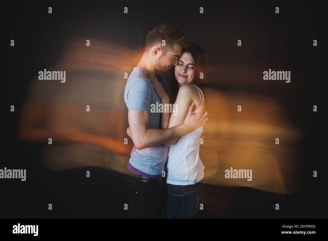 Couple embracing posing in studio Stock Photo