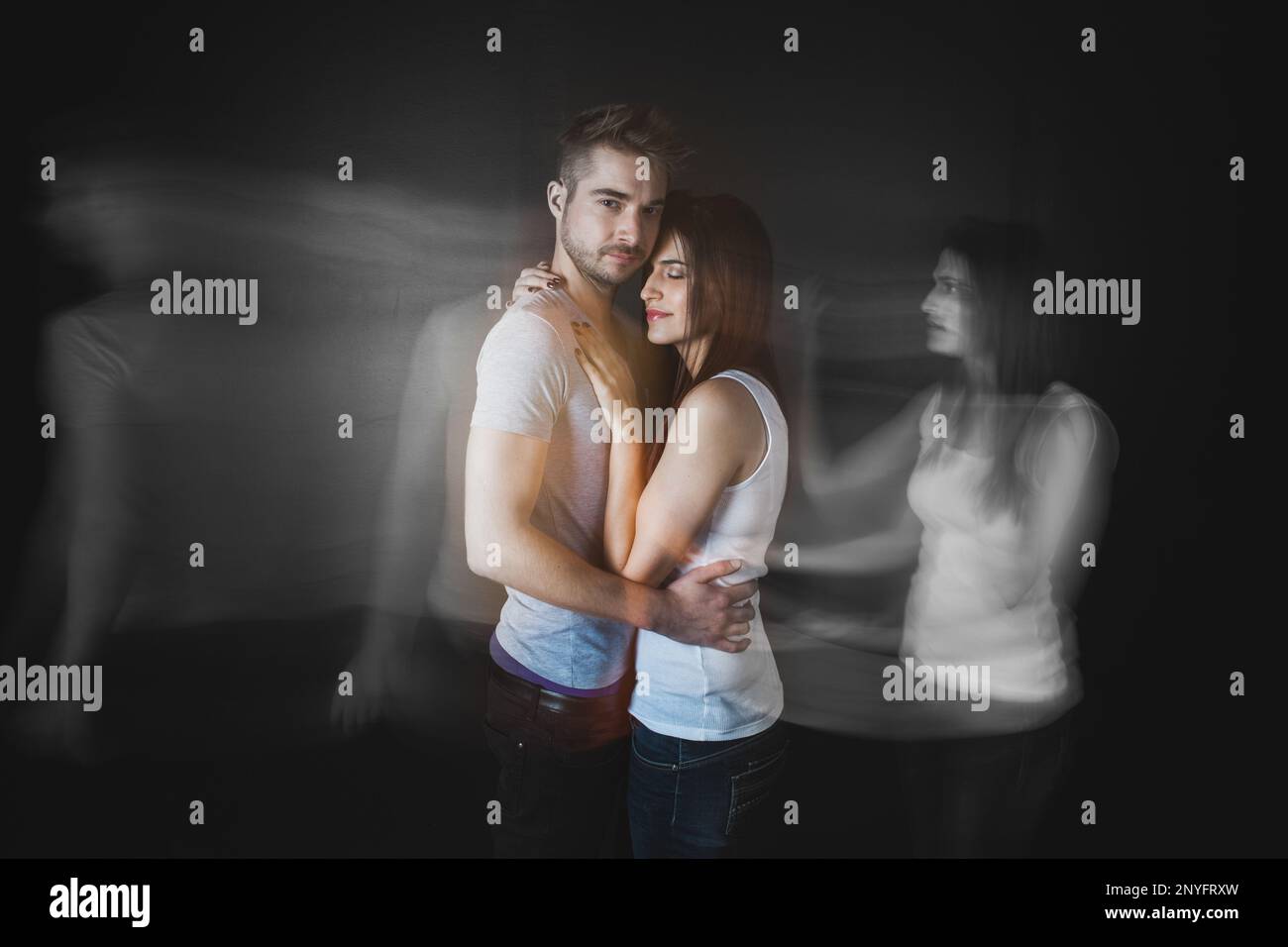 Couple embracing posing in studio Stock Photo