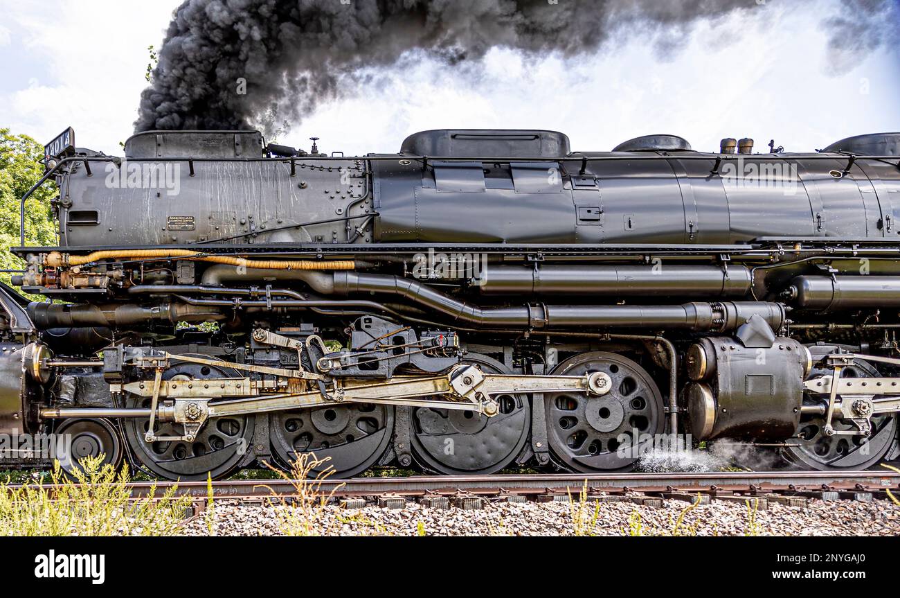 An industrial steam engine emitting steam from its exhaust pipes Stock