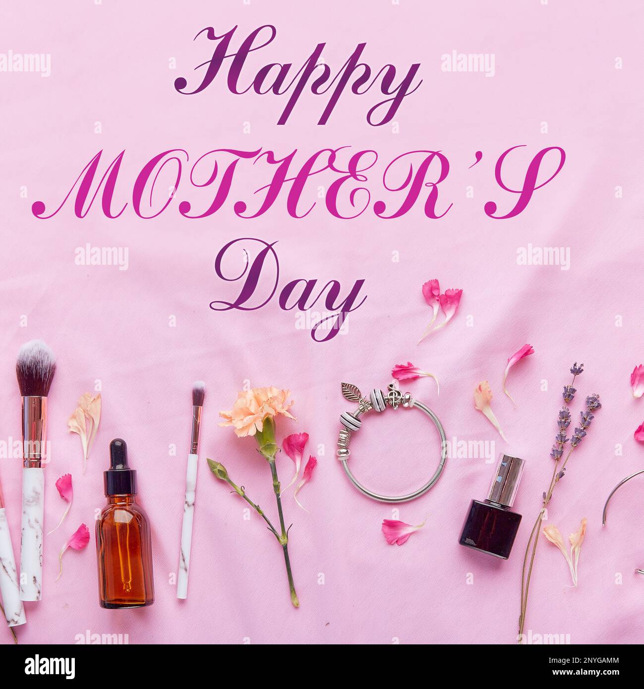 Happy Mothers Day text postcard with accessories and cosmetics among petals. Stock Photo