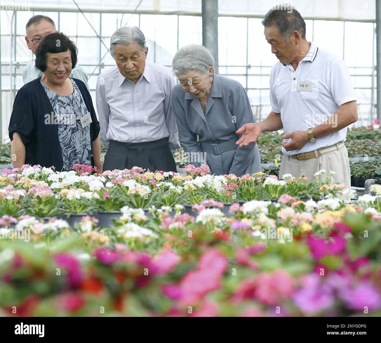 Japanese Emperor Akihito and Empress Michiko visit a farm house to see