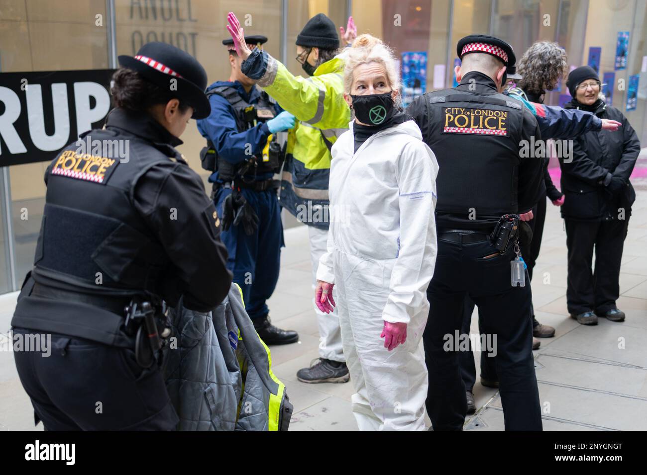 London, England, UK 02/03/2023 Extinction Rebellion targets UK Finance's headquarters at Angel Court in protest at corruption in the banking system and how it prioritises profit over people and planet. Six protesters threw pink paint (a concoction of pond dye, water and guar gum) at the windows and covered them with posters of Rishi Sunak saying This Bill Will Kill. Later all six were arrested. The action coincides with passing of the Financial Services and Markets (FSM) Bill through the committee stage in Parliament and in its current form includes no environmental protections. Stock Photo