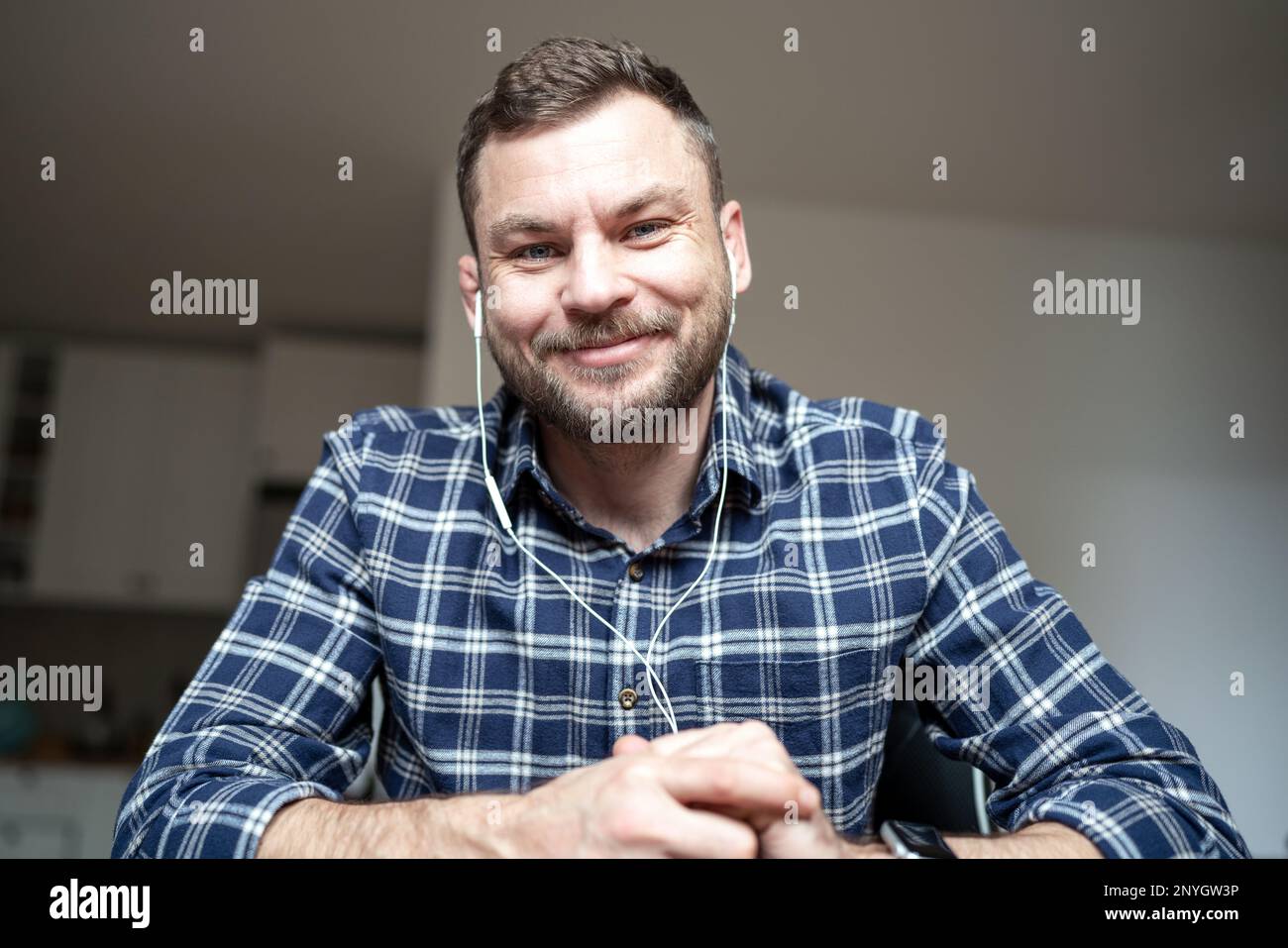 Man sitting desk smiling in web camera while video calling. Stock Photo