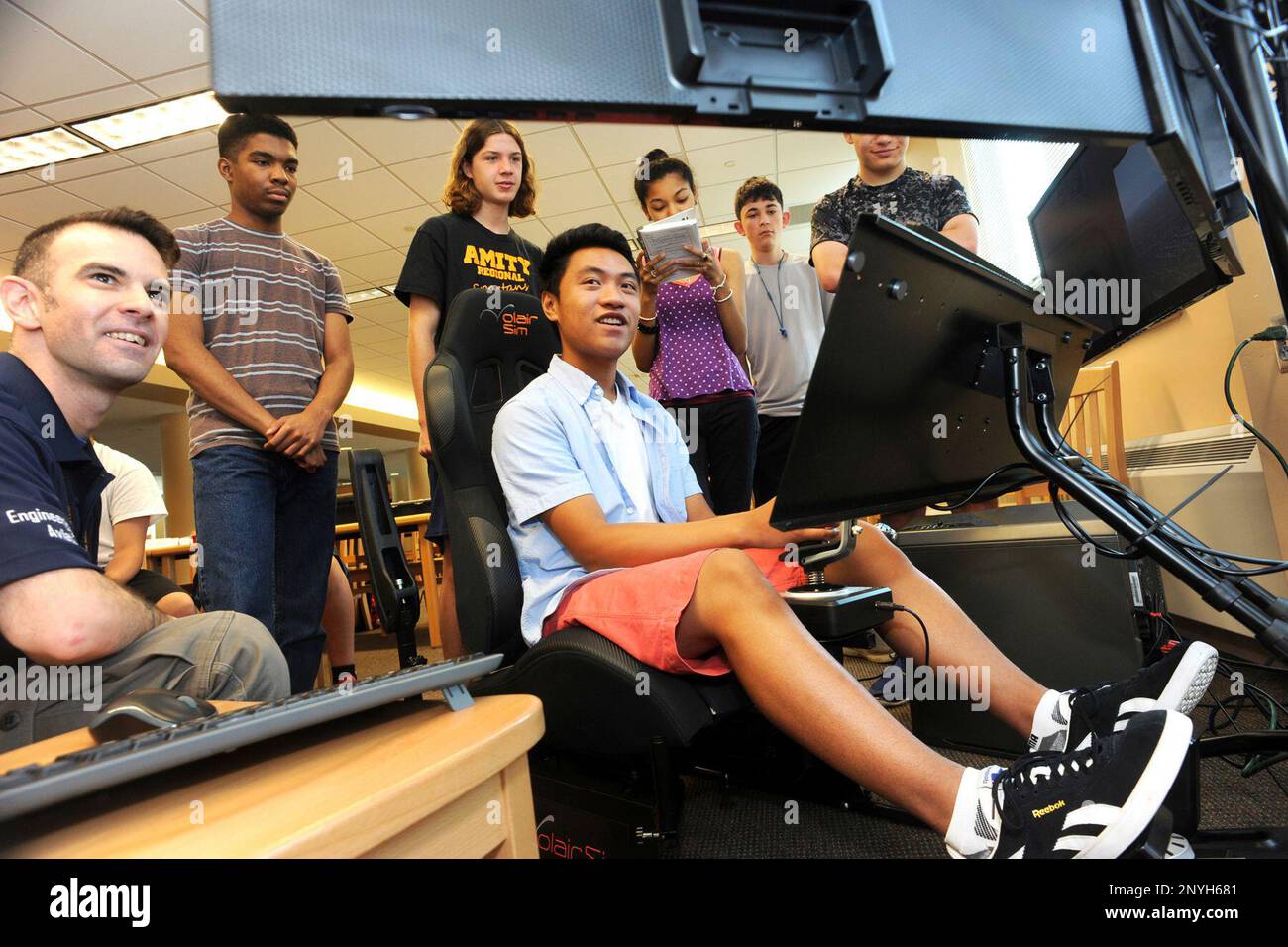 ADVANCE FOR THE WEEKEND OF JULY 22-23 AND THEREAFTER - In a July 13, 2017  photo, Gemo Yesil, left, looks on as student Arthur Lihar flies a flight  simulator during an Engineering