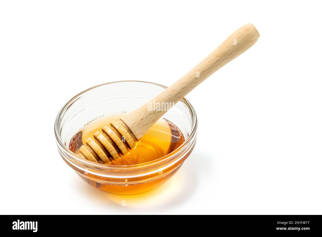 Honey bowl and dipper isolated on white background as package design element. Clipping path included. Stock Photo