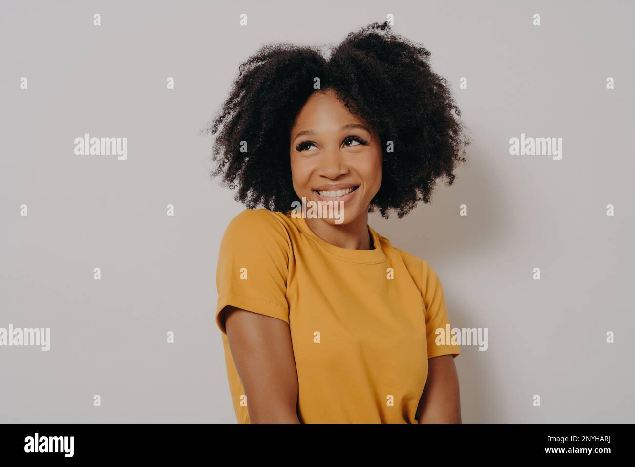 Studio shot close up portrait of casually dressed cute african american girl with funny astonished face expression. Emotional young mixed race woman w Stock Photo
