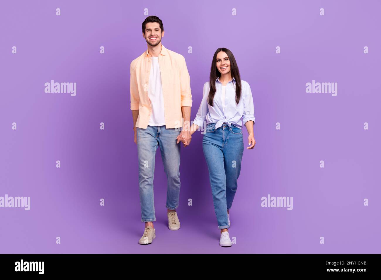 Full body photo of two cheerful nice partners hold arms walking good ...