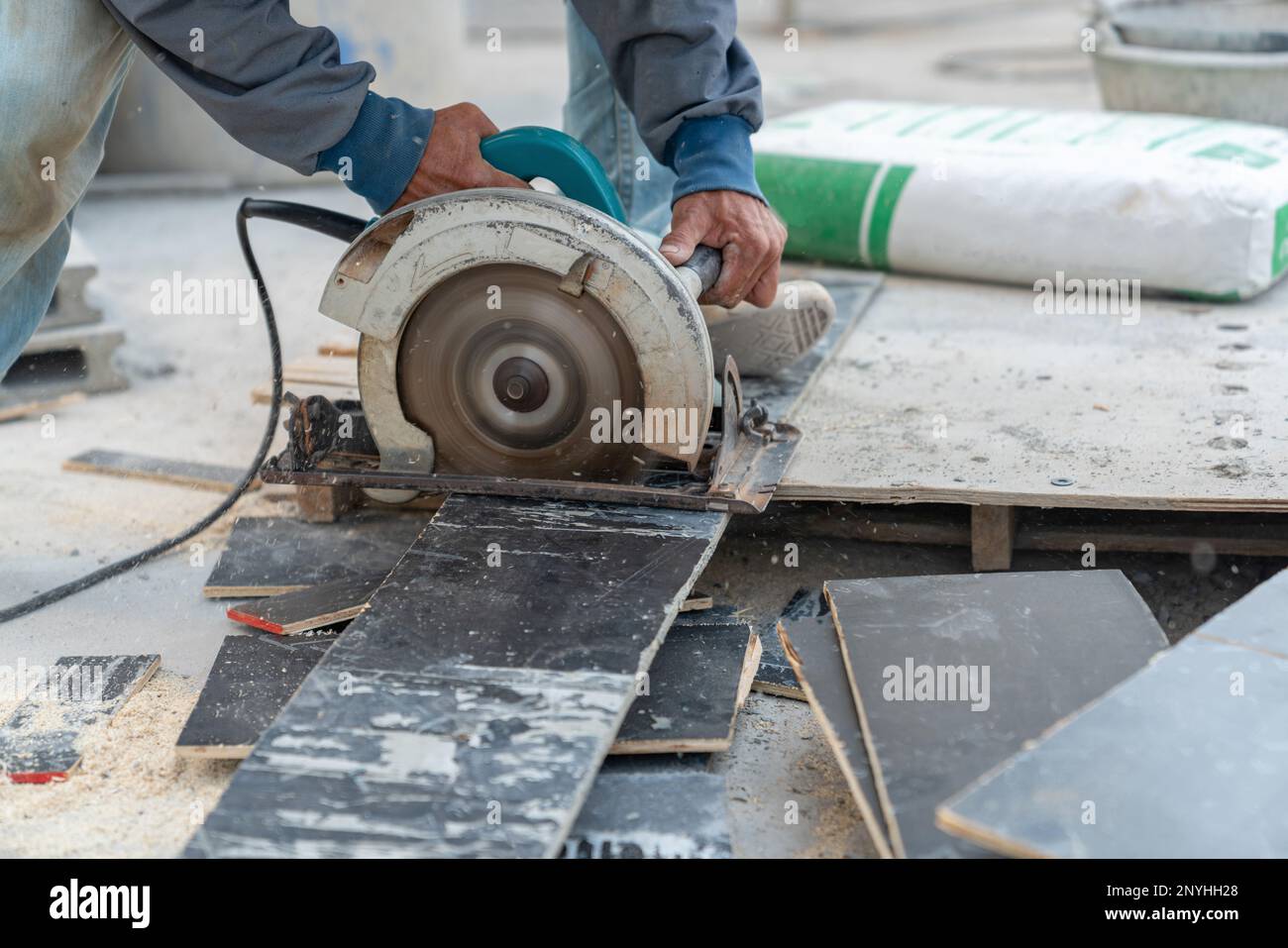 Worker use circular saw cutting plywood for make formwork pour cement