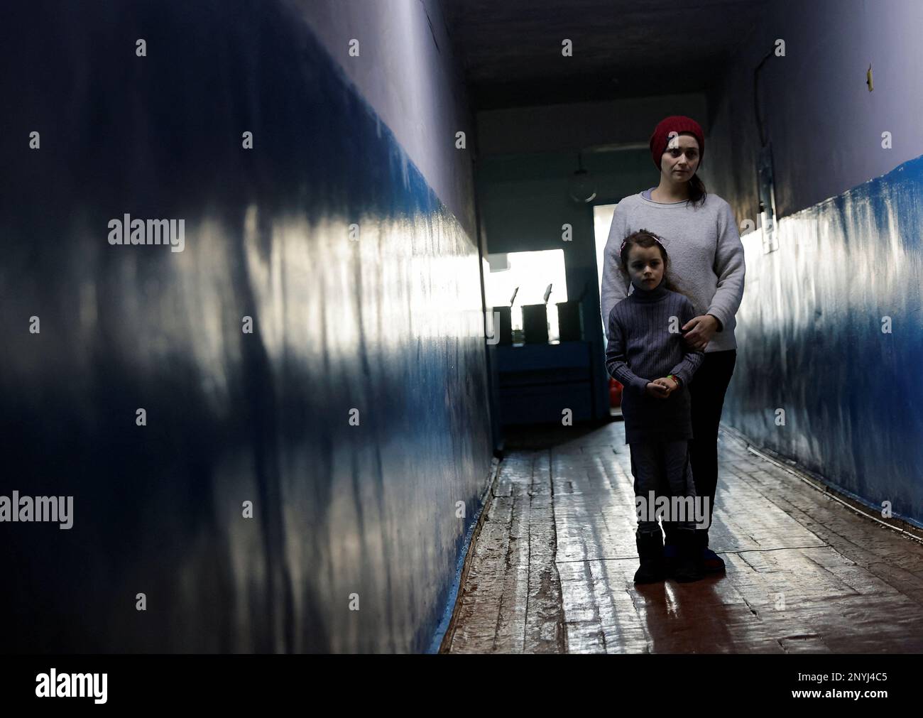 Yelena Vyacheslavskaya, 35, and her daughter Kira, 7, evacuated from Bakhmut district in the course of Russia-Ukraine conflict, stand in a corridor of a temporary accommodation centre in a local dormitory in Shakhtarsk (Shakhtyorsk) in the Donetsk Region, Russian-controlled Ukraine, March 2, 2023. REUTERS/Alexander Ermochenko Stock Photo