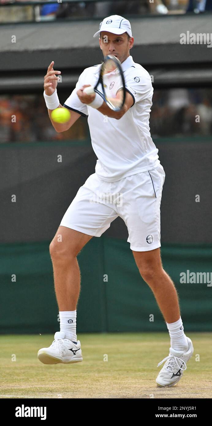 Gilles Muller of Luxembourg hits a shot during the gentlemen's singles  fourth round of the Wimbledon tennis tournament against Rafael Nadal of  Spain at All England Tennis Club in London on July