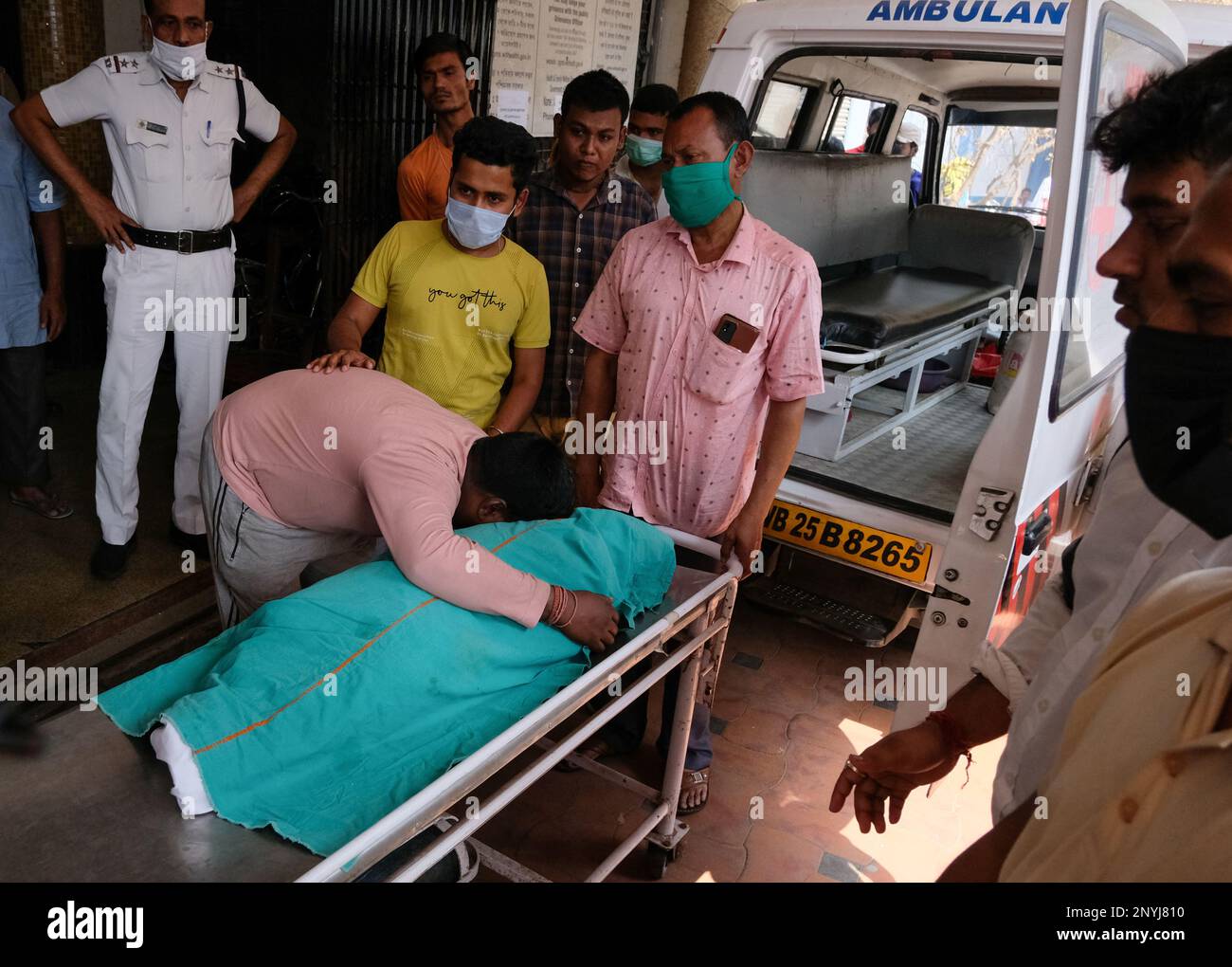 editors-note-image-depicts-death-a-man-cries-next-to-the-body-of-his
