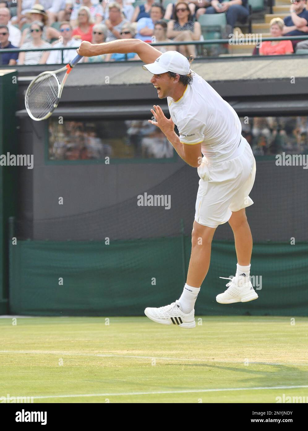 Dominic Thiem of Austria hits a serve during the second round of the Wimbledon tennis tournament against Gilles Simon of France at All England Tennis Club in London on July 6, 2017.