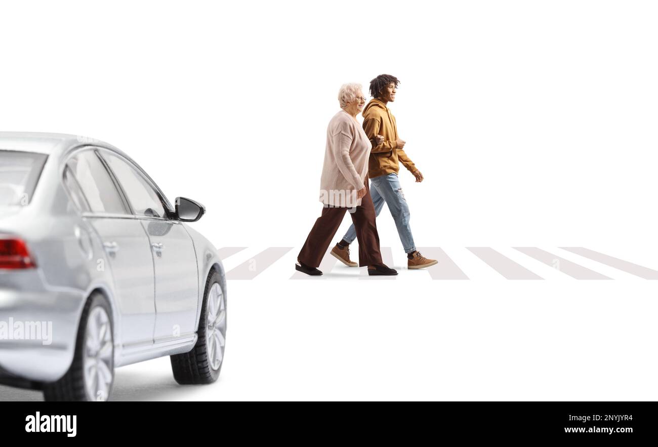 Young african american man helping a senior woman crossing a street ...