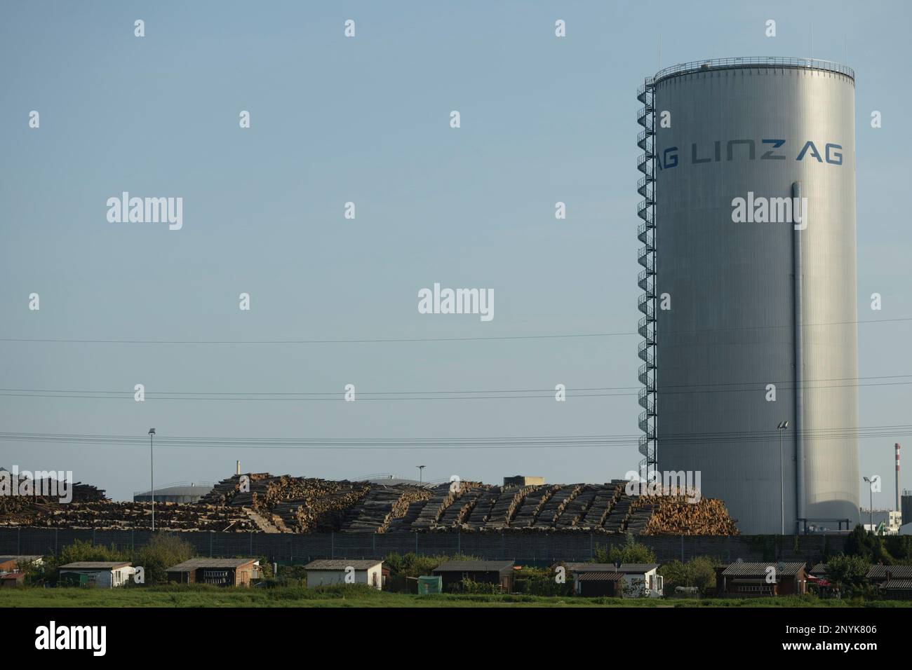 Linz / Austria - In a biomass power plant, huge piles of logs are stored, waiting to be burned and turned into climate damaging CO2. Stock Photo