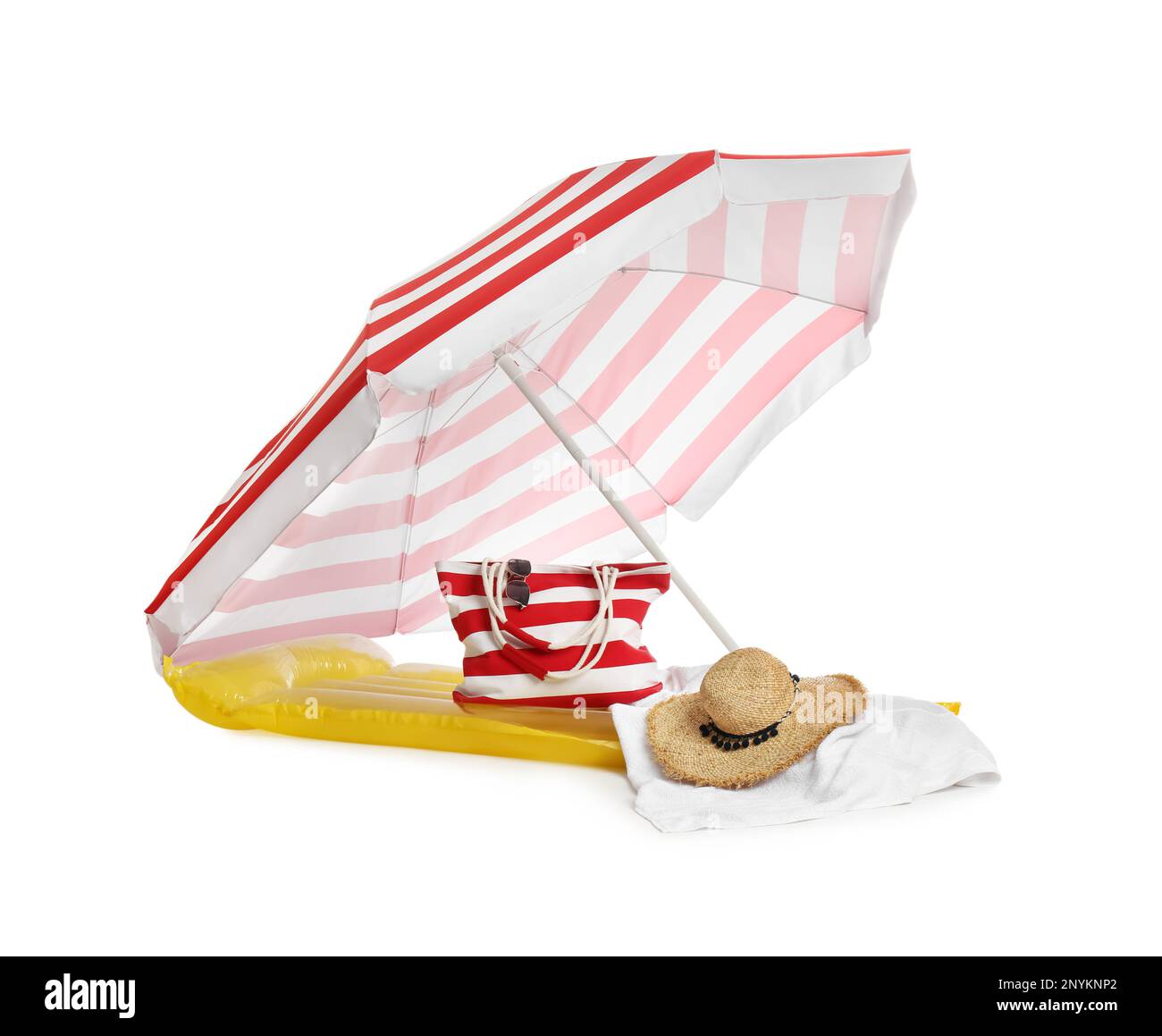 Open striped beach umbrella, inflatable mattress, bag and accessories on white background Stock Photo