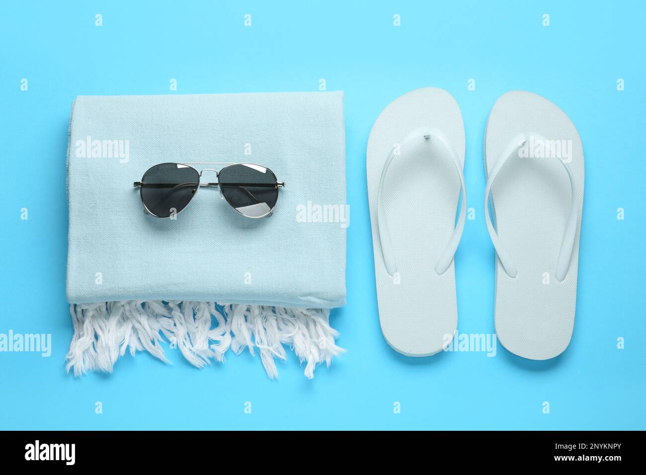 Flat lay composition with different beach objects on light blue background Stock Photo