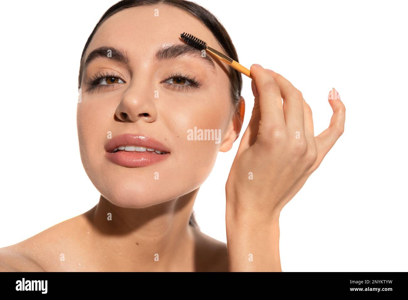 woman styling eyebrows with brush and gel isolated on white