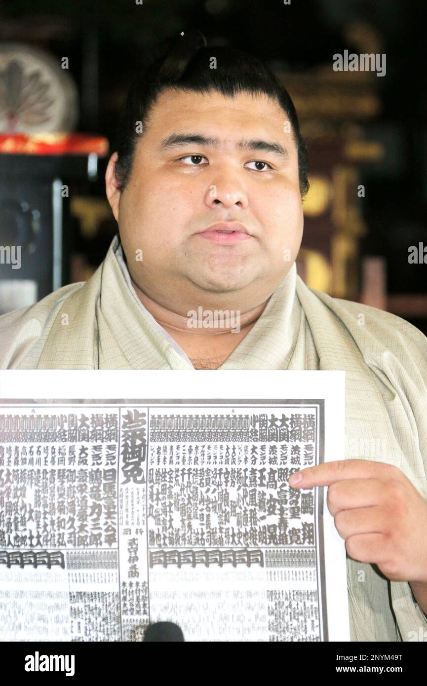 Newly ozeki promoted Takayasu poses with banzuke, the rankings list