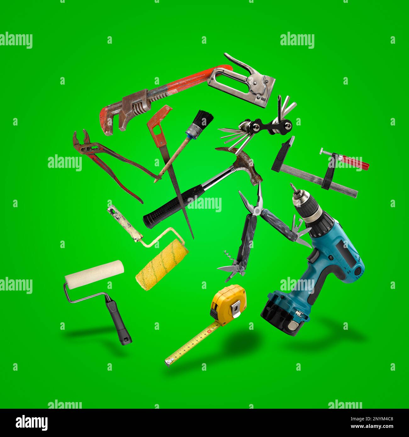 Floating Set of work tools on green gradient Stock Photo