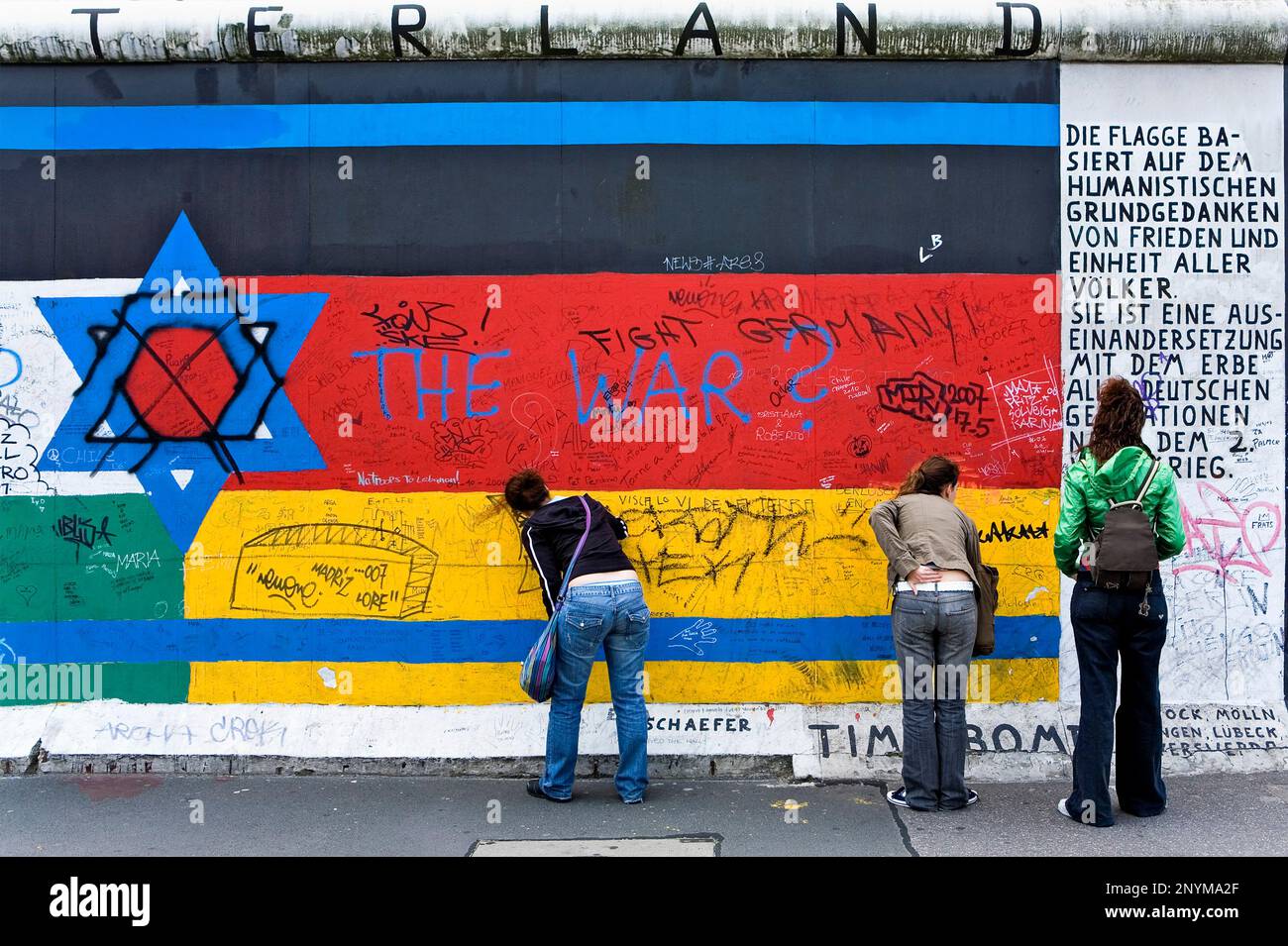 East Side Gallery.writing mensages in the wall on a drawing of  stars Jews and the German flag.Berlin. Germany Stock Photo