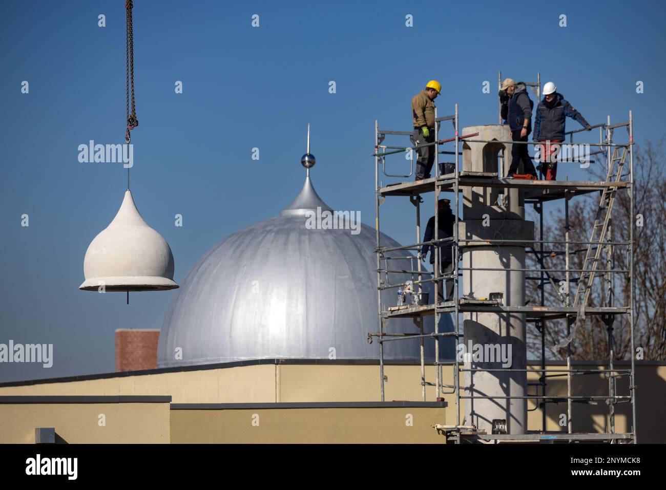 Erfurt, Germany. 02nd Mar, 2023. Workers assemble the individual parts for a minaret with the help of a crane. The eight-meter-high prayer tower is now part of the newly built Ahmadiyya mosque. Credit: Michael Reichel/dpa/Alamy Live News Stock Photo