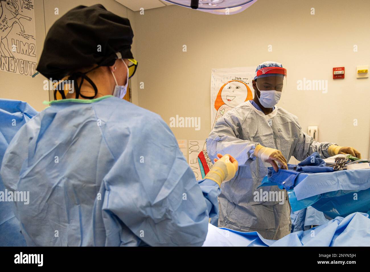 Instructors act as surgeons during a mock surgery while 68D operating