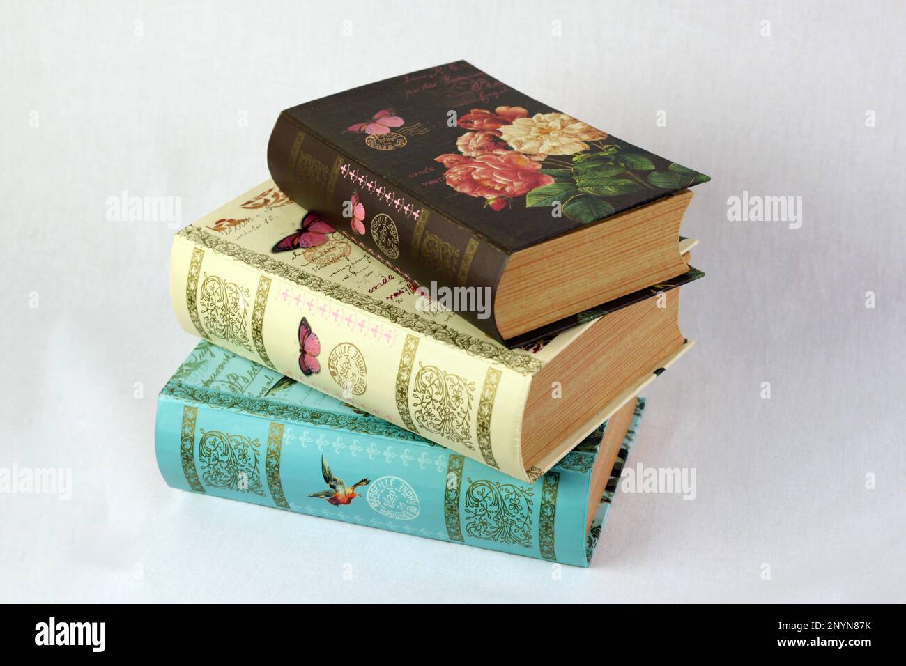 The three book boxes featuring a floral pattern on the front cover ...